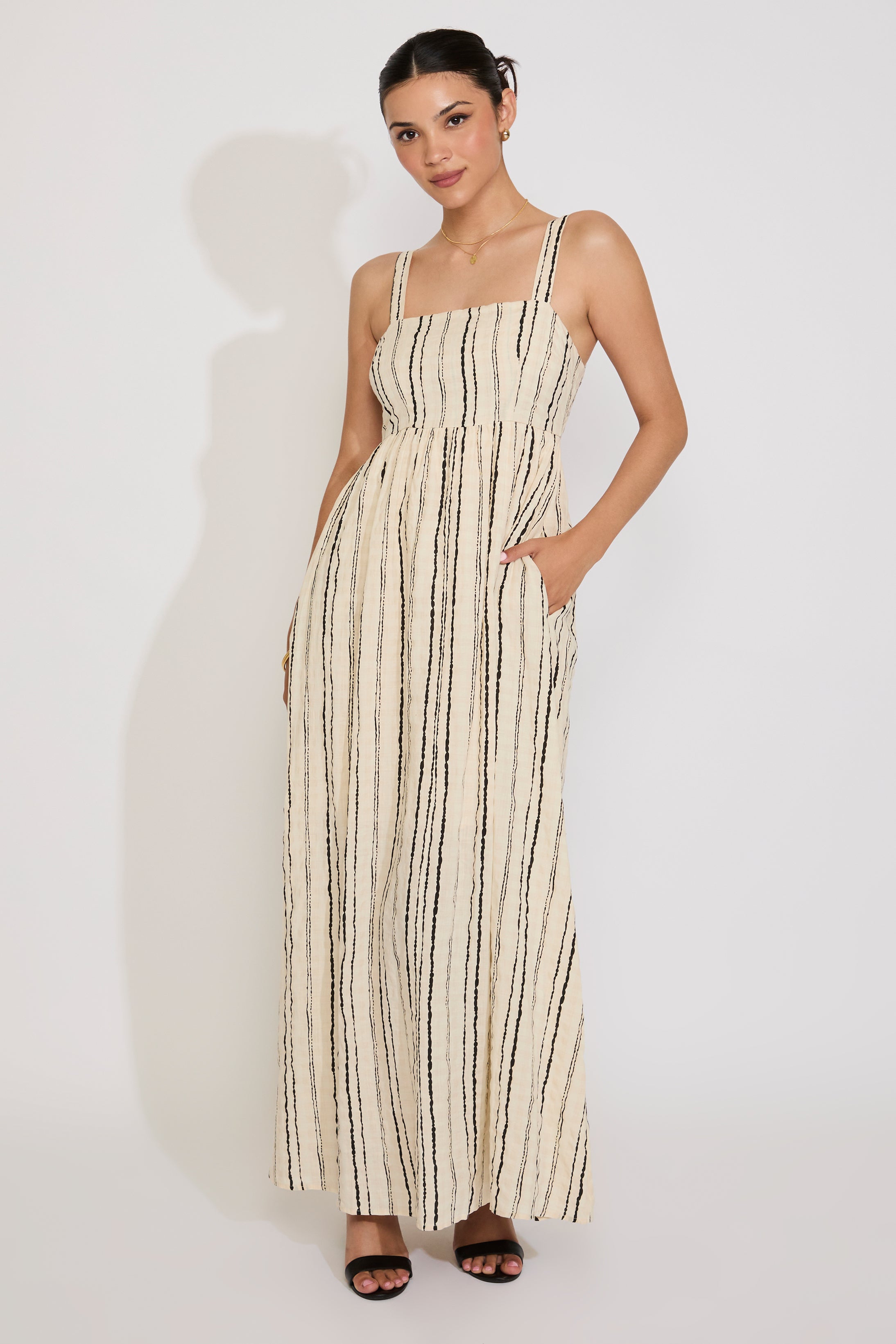 Woman wearing a striped dress on a white background