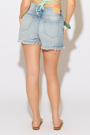 Model is wearing medium denim shorts with a mint triangle pointed sequins top on a white background.