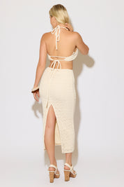 Model is wearing a natural crochet maxi dress with cutout and wood rings details on a white background.