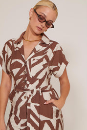 SHORT SLEEVED BUTTON-UP GRAPHIC PRINT WAIST-TIE JUMPSUIT