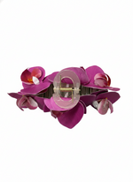 A pink TRIPLE FLOWER CLAW CLIP on a white background.